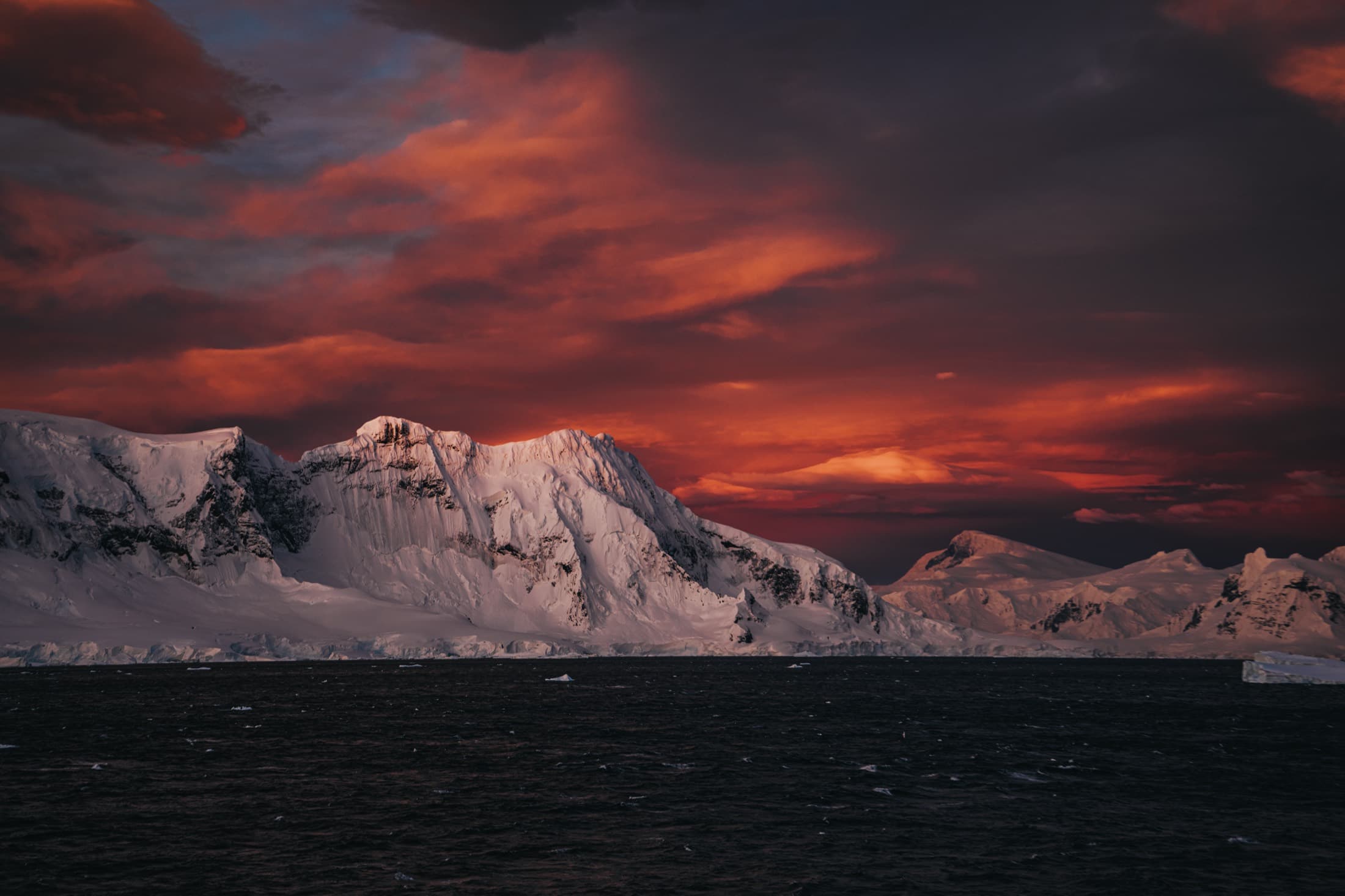 Antarctic peaks under a red sunset